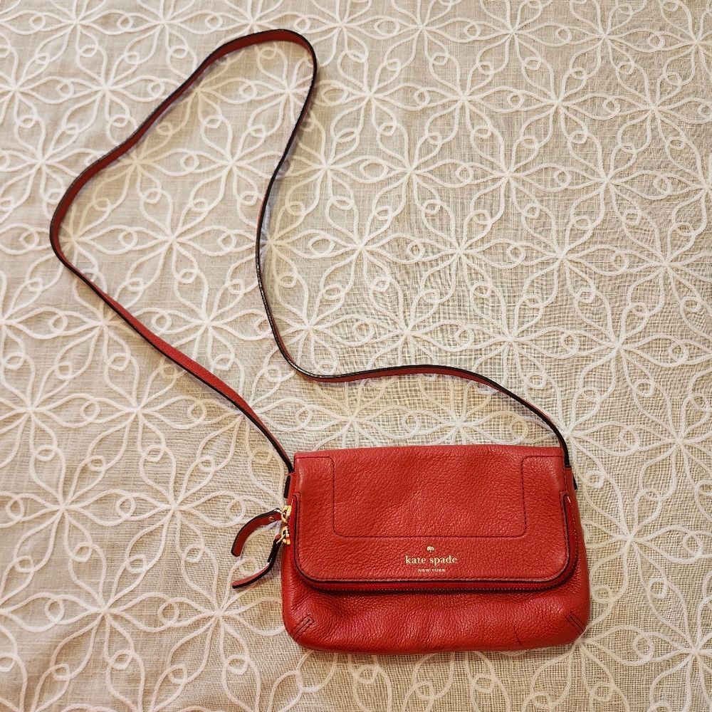 Kate Spade New York Mariana Mansfield leather crossbody bag in persimmon red. 